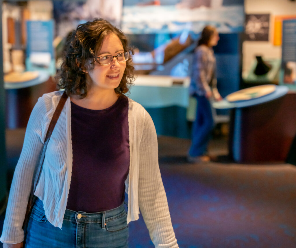 Visitor smiling and exploring the gallery